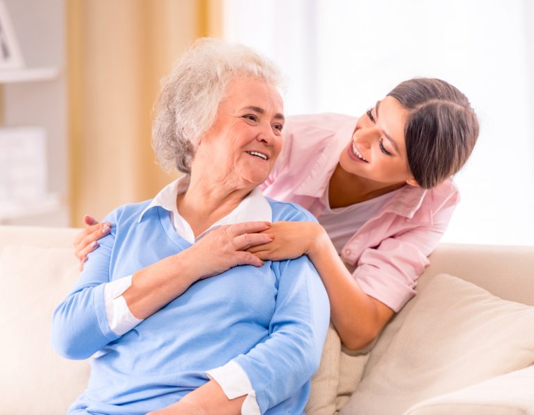 Care taker visiting with resident in respite care