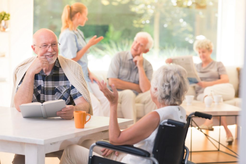 Residents sitting at tables talking with each other