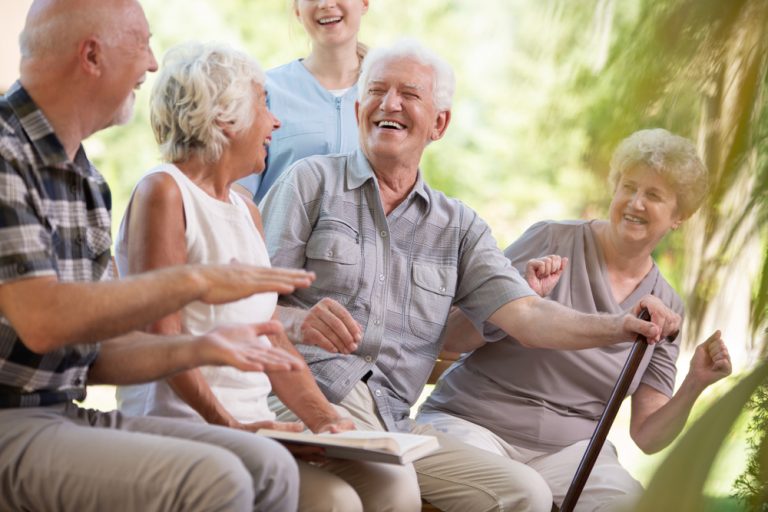 Elderly sitting outside talking 