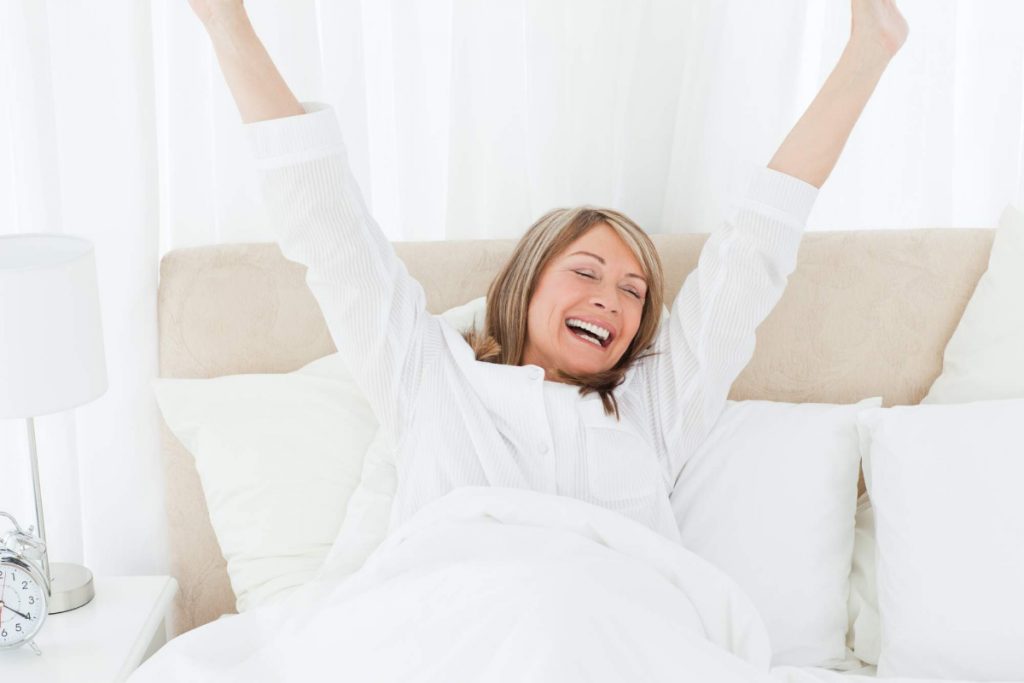 Elderly woman waking up in the morning