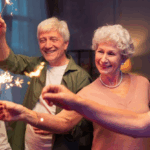 Seniors celebrating with sparklers, smiling and enjoying a festive Fourth of July evening together.